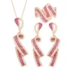 Complete 3 piece rose gold simulated ruby twist ribbon jewelry set earrings necklace ring white background