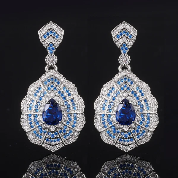 Matching pair baroque fan shaped teardrop simulated sapphire long dangle drop earrings isolated black reflective background