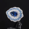 Single baroque fan shaped teardrop simulated sapphire adjustable open ring macro close-up black background