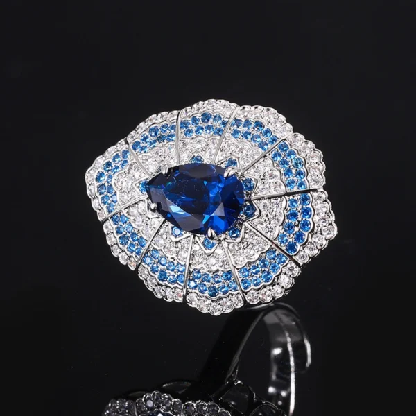 Single baroque fan shaped teardrop simulated sapphire adjustable open ring macro close-up black background