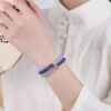 The "Blue Wisdom" lapis lazuli and aquamarine bracelet worn on a wrist, showing how it looks when worn