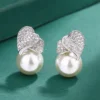 double-heart-cz-imitation-pearl-drop-earrings-green-background-studio-detail-photo