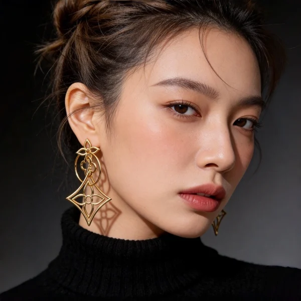 Side profile shot female model wearing hollow four leaf clover geometric long gold drop earrings