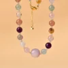 Macro close-up partial shot multi gem crystal love attraction clavicle necklace focusing on central kunzite focal bead and surrounding crystal texture