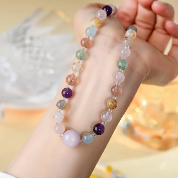 Dual-use wrap shot natural multi gem crystal clavicle necklace wrapped around female wrist showing flexible length feature