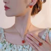Female model wearing rose cut orange cubic zirconia 3 piece jewelry set earrings necklace ring