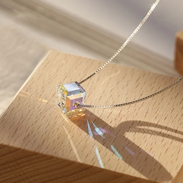 Macro close-up of S925 sterling silver aurora cube crystal choker necklace, iridescent faceted 7.5mm cube pendant on slim silver box chain