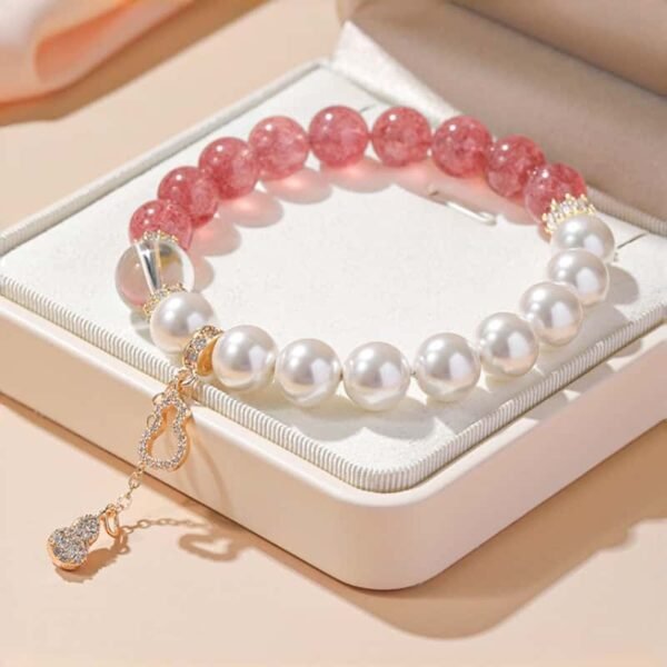 Strawberry quartz and imitation pearl bracelet displayed in a light-colored gift box, elegant jewelry gift