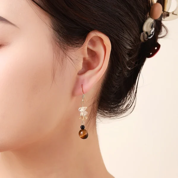 Lifestyle photo single tiger eye citrine black agate dangle earring worn on female ear, showing 5.0cm length hanging effect, natural daily temperament matching
