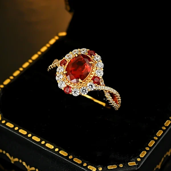 Vintage oval simulated ruby halo twist split shank ring laid inside black trimmed jewelry box studio product photo