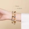 Two sizes of natural yellow rutilated quartz couple bracelet (7-8mm & 9-10mm) worn on wrist for size reference
