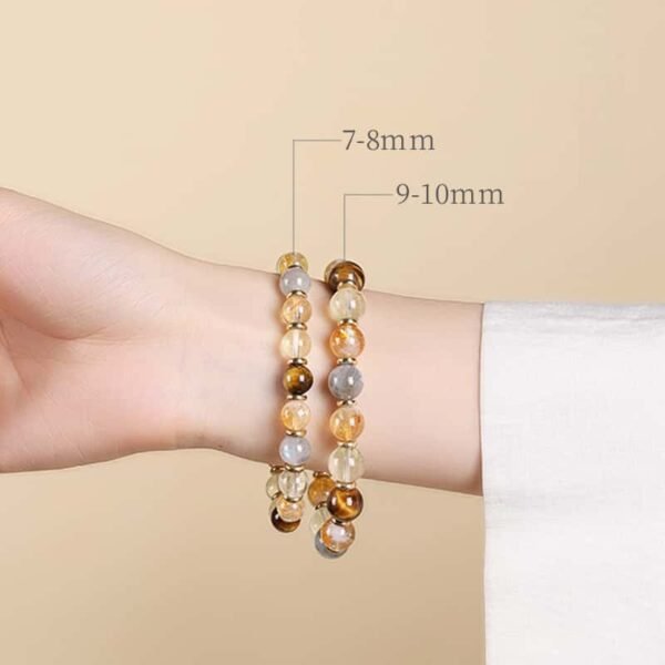 Two sizes of natural yellow rutilated quartz couple bracelet (7-8mm & 9-10mm) worn on wrist for size reference